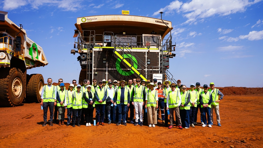 The delegation and a team from Australian company Fortescue in front of a prototype hydrogen-powered dump truck at the Christmas Creek iron ore mine. Copyright: Fortescue